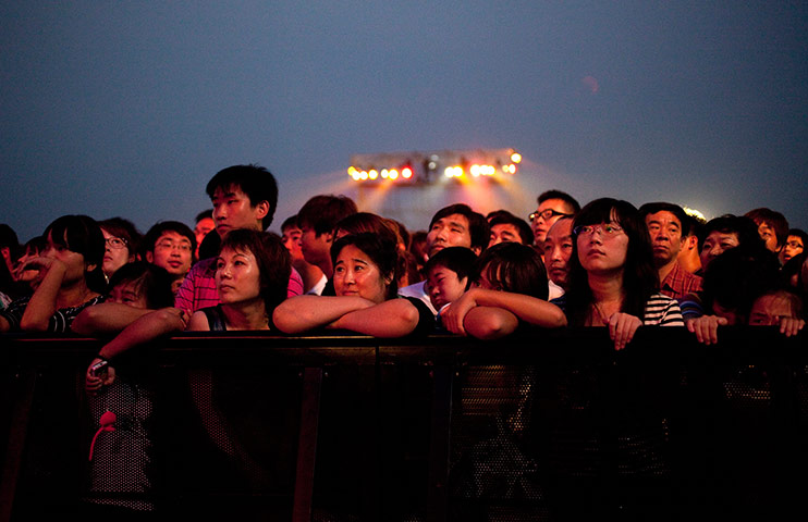 24 hours in pictures: Fans waiting for a performance to start at the FUN Music Festival , Beijing