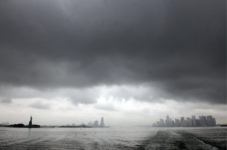 24 hours in pictures: New York City skyline in the dark clouds as Hurricane Irene approaches