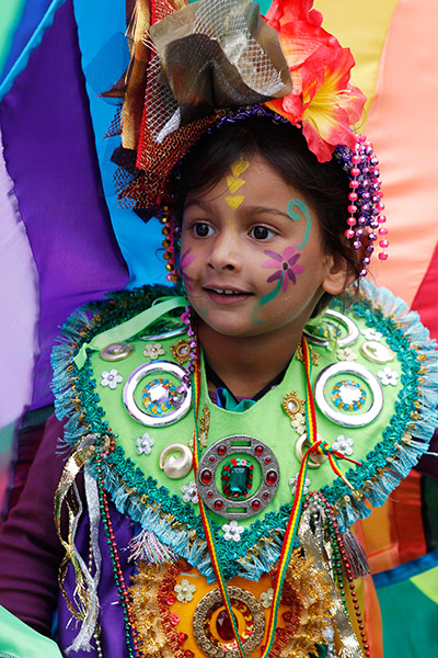 Notting Hill carnival: A girl reacts as revellers parade through the street, Notting Hill Carnival