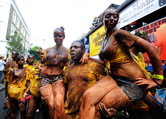 Notting Hill carnival: Performers covered in chocolate take part in the Notting Hill Carnival