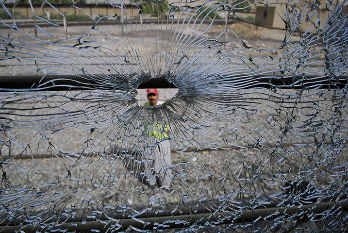24 hours: Mach, Pakistan: A rescue worker is seen through the bullet-riddled window