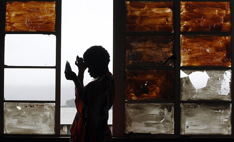 24 hours: Ludzidzini, Swaziland: A girl prepares to take part in annual Reed Dance
