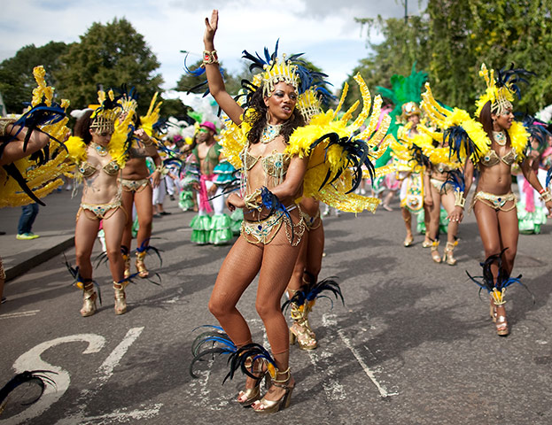 Notting Hill - Day 2: A reveller dances as they parade through the streets