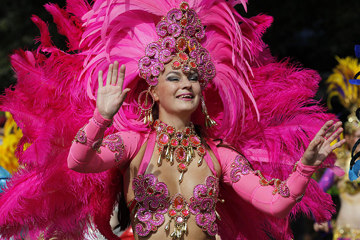 Notting Hill - Day 2: A reveller dances as they parade through the street