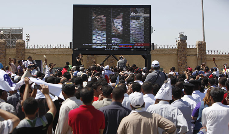 Mubarak in court: The crowd watches on a giant TV screen