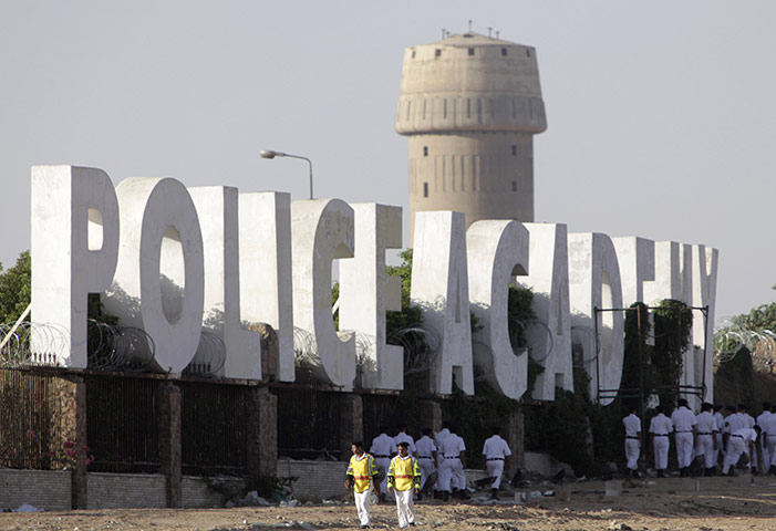 Mubarak in court: Police officers patrol outside the police academy in Cairo 