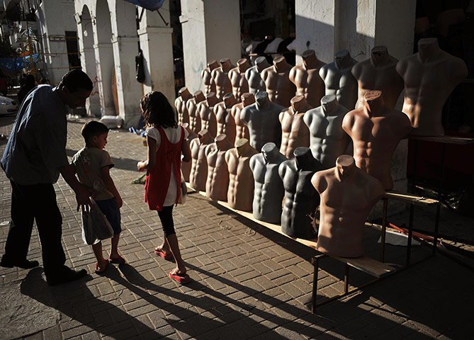 24 hours: Tripoli, Libya: Children walk past a stall at Rashid Street market