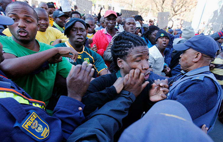 Malema demonstrations: Police restrain a supporter of ANC Youth League leader Julius Malema