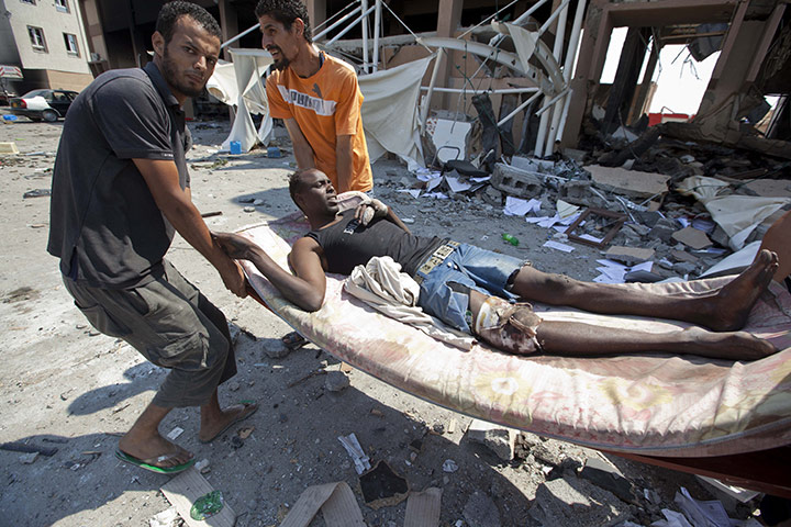 Sean Smith in Libya: 26 August: Rebels bring prisoners out of a building damaged in fighting 