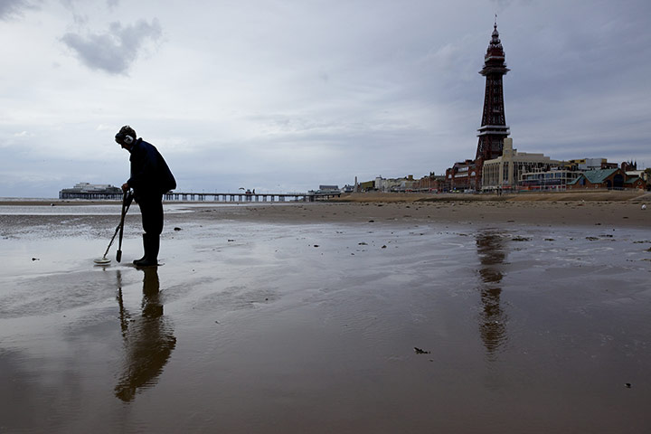 Summer 2011: Blackpool: A metal detector user on Blackpool Beach 