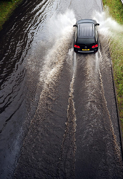 Summer 2011: Tynemouth: A car drives along a flooded section of the A1058