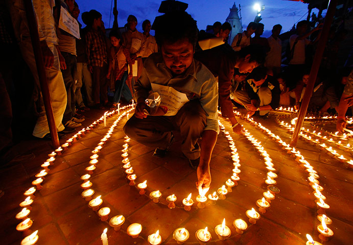24 hours in pictures: Kathmandu, Nepal: A family member lights candles