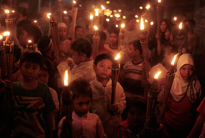 24 hours in pictures: Jakarta, Indonesia: Indonesian Muslim children carry torches