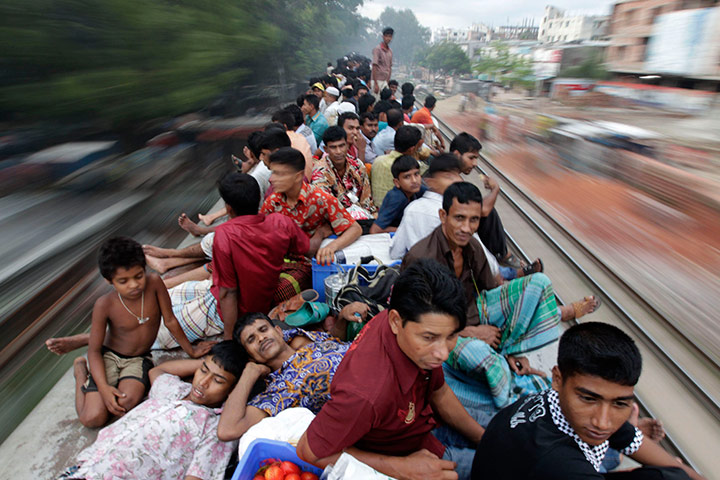 Eid Festival: Passengers sit on top of an overcrowded train as it heads for Jamalpur