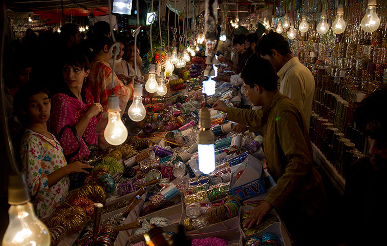 Eid Festival: Women buy traditional bangles at a shop for Eid in Islamabad, Pakistan