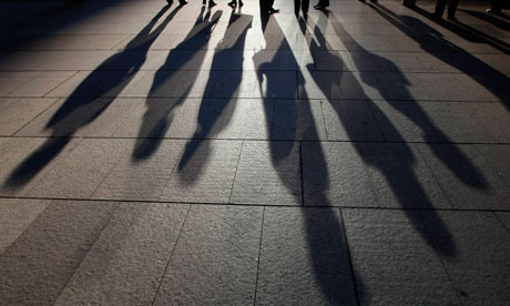 Office workers line up at a traffic light 