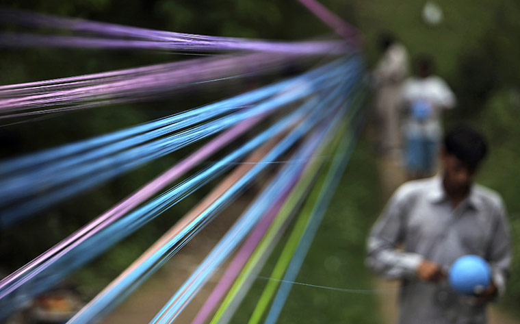 24 Hours : Jammu, India: A craftsman prepares threads for flying kites