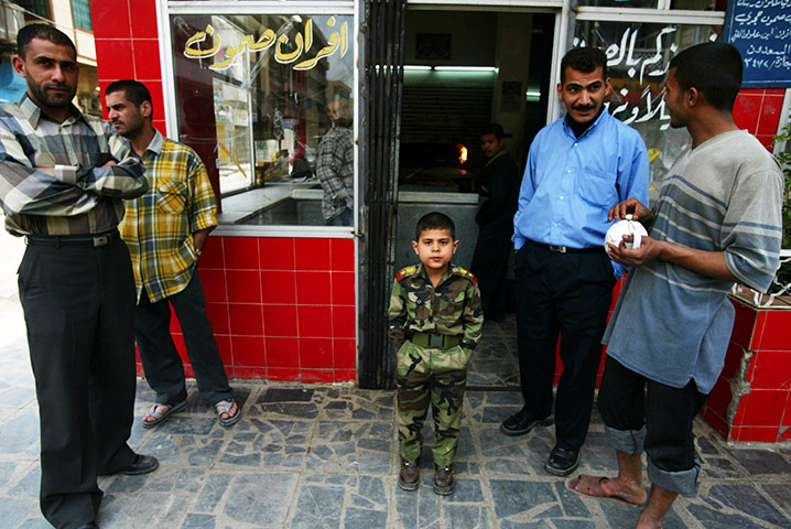 Sean Smith Frontlines: A child dressed in an Iraqi army uniform 