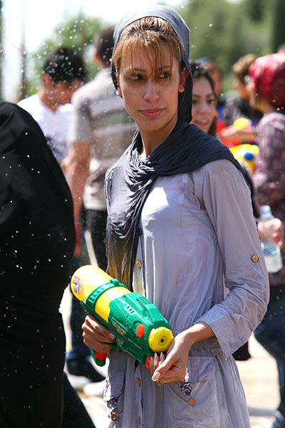 Water gun festival: A woman holds a toy gun