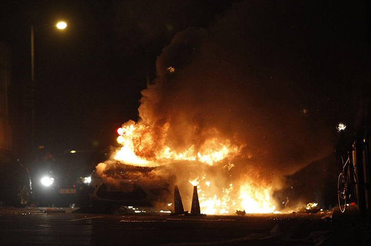 Tottenham riots: A police car burns on a street in Tottenham