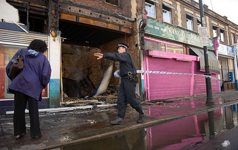 Tottenham riots: A police officer sets up a cordon