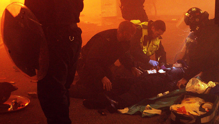 Tottenham riots: Police attend to an injured policeman 