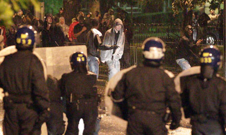 Police clash with youths near a Currys store that was broken into in Brixton