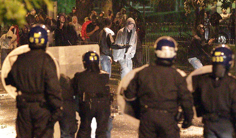 London riots: Police clash with youths in Brixton