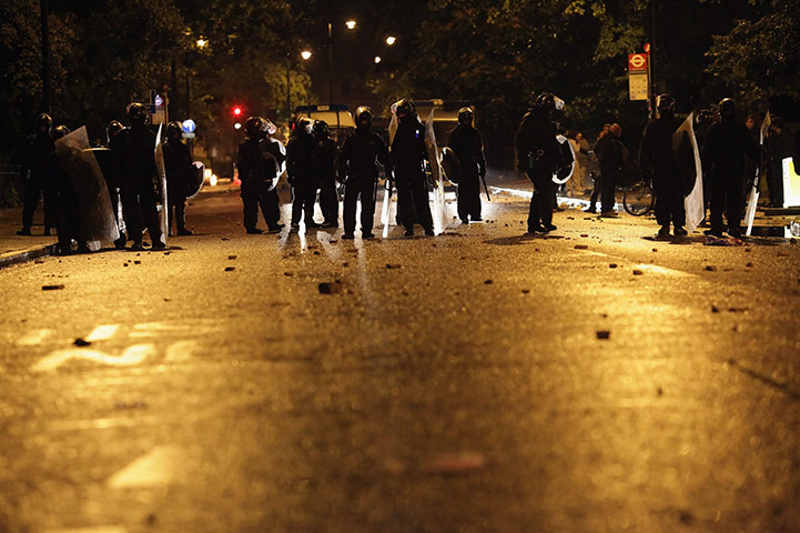 London riots: Police are confronted by several hundred youths in Brixton