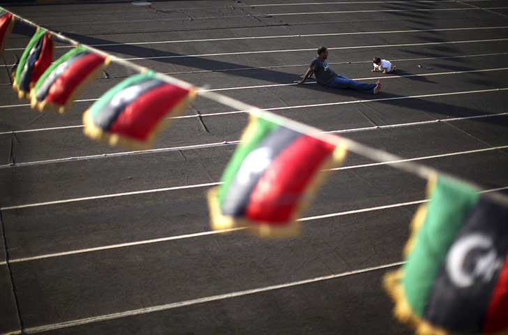 24 hours in pictures: A Father and daughter play in Benghazi, Libya