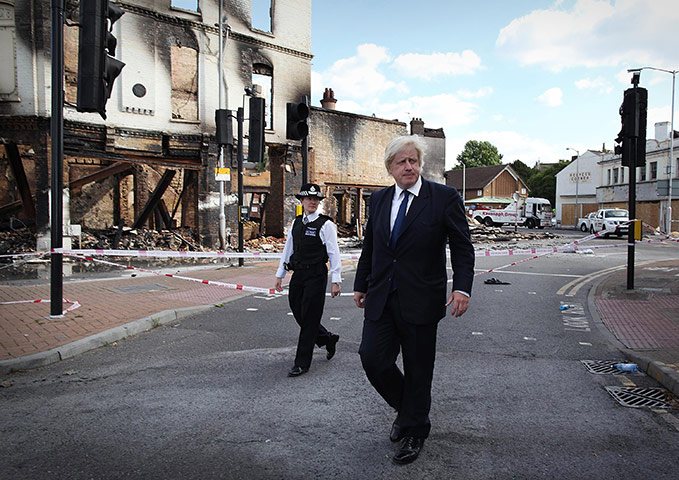 London riots day 4 update: Boris Johnson walks near burnt out Reeves Corner furniture store in Croydon