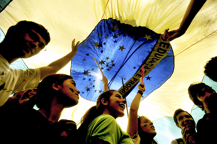 24 hours in pictures: Brasilia, Brazil: A group carry Brazil's flag during a student march
