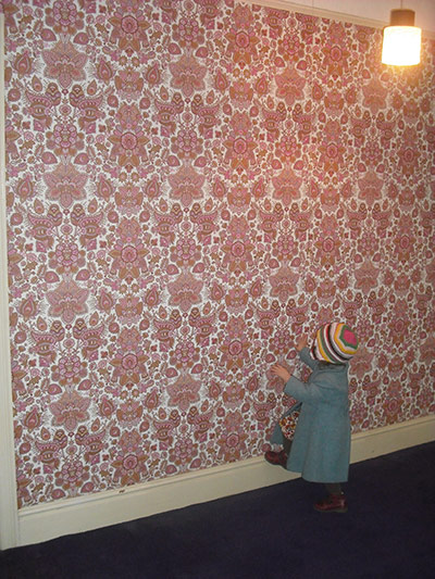 Vintage: A young girl staring at wallpaper by Dominga Leone
