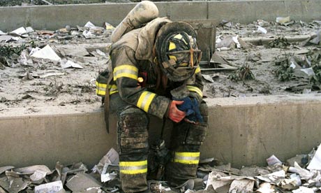 A firefighter rests for a moment amid the rubble of the World Trade Centre