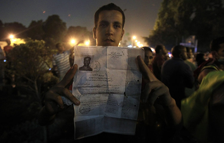 Egypt Riots: An Egyptian protester holds documents from the Israeli embassy in Cairo