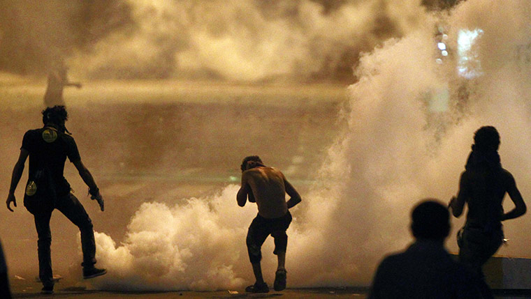 Egypt Riots: Protesters flee from tear gas at the Israeli embassy in Cairo