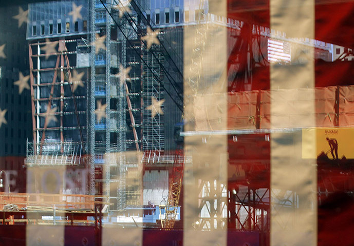24 Hours: The World Trade Center construction site is reflected in a shop window