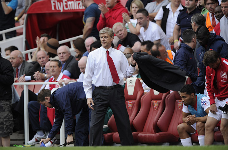 Arsenal v Swansea: Arsene Wenger gets his coat after the final whistle blows