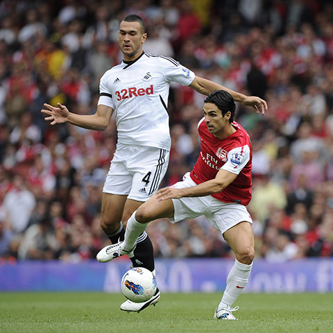Arsenal v Swansea: Mikel Arteta skips past Steven Caulker