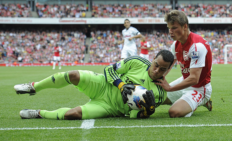 Arsenal v Swansea: Michael Vorm dives at the feet of Andrey Arshavin