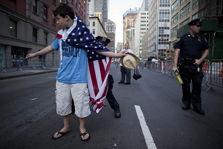 9/11 anniversary: A Police officer body searchs a member of the public 