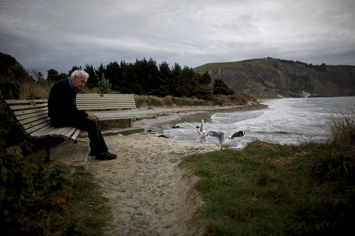 24 hours in pictures: A man sits on a bench near Port Chalmers 
