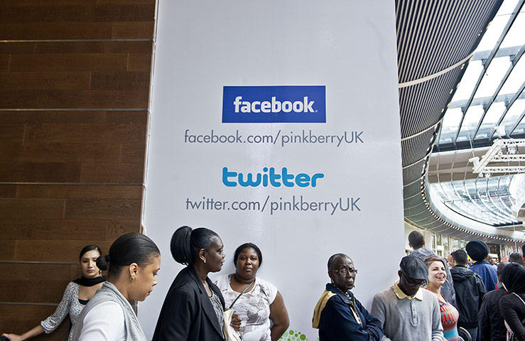 Westfield Stratford: Shoppers stand near a sign for a frozen yoghurt store