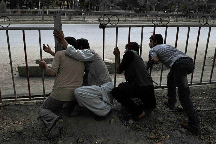 Kabul embassy attacks: Local men take a look at the building where the militants are hiding 