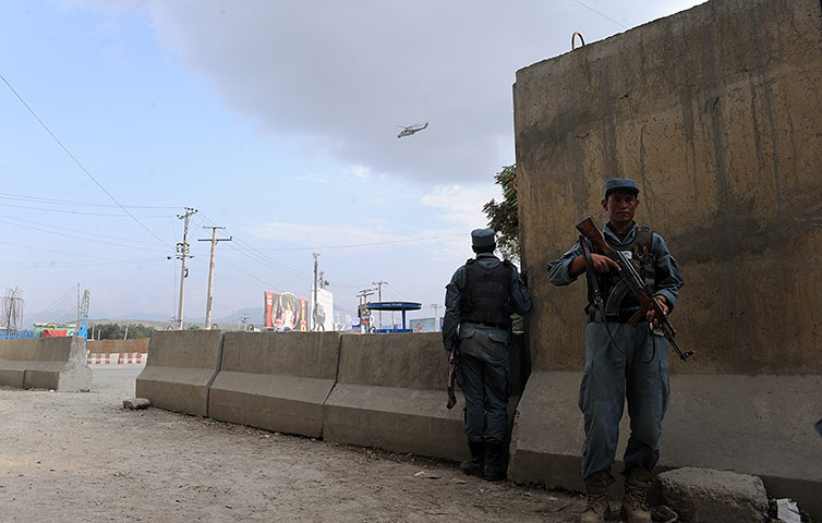 Kabul embassy attacks: Afghan police take cover as a helicopter flies over the area 