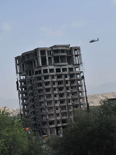 Kabul embassy attacks: A NATO helicopter flies over the building where Taliban fighters are hiding
