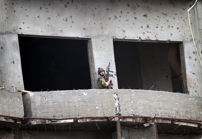 kabul seige: A coalition soldier moves around the building during the seige
