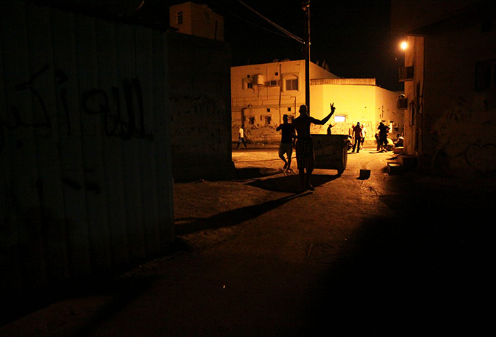24 hours in pictures: Bahraini anti-government protester gestures after clashes with riot police