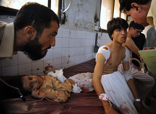 24 hours in pictures: Local residents chat with wounded school children at a hospital, Pakistan