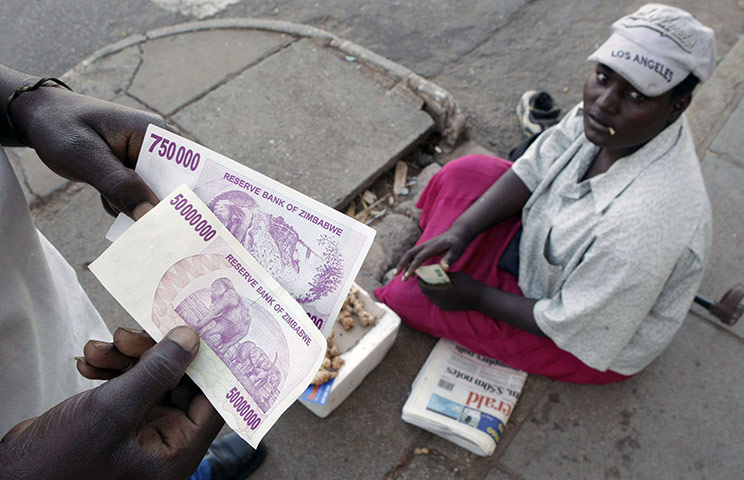 Robert Mugabe: April 2008: A Zimbabwean holds a newly issued fifty million dollar note